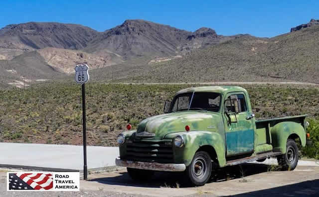 Green pickup truck ready to roll on Route 66 between Kingman and Oatma