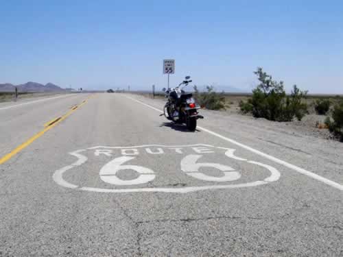 Motorcycle rider stopping for a photo op in the middle of Route 66