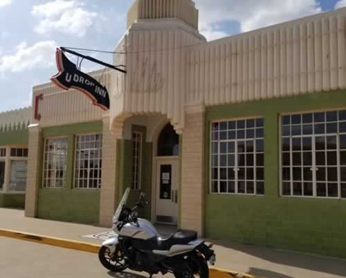 Motorcycle and rider visiting the U-Drop Inn in Shamrock, Texas on Historic Route 66