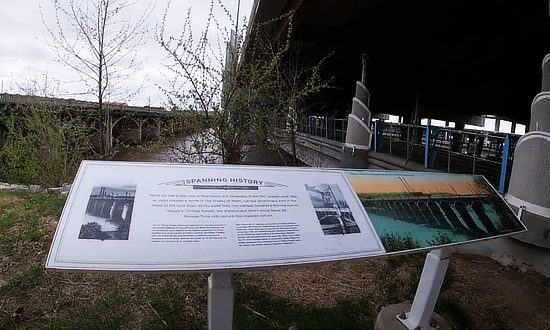 Sign at the Cyrus Avery Centennial Plaza near the entrance to the observation walkway under I-244