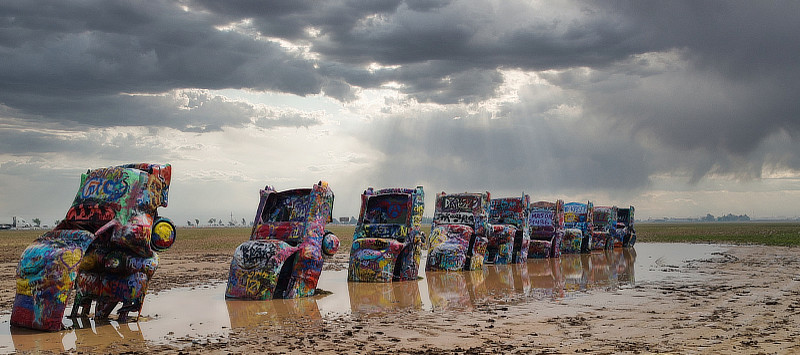 A muddy, rain soaked Cadillac Ranch on Interstate 40 just west of Amarillo
